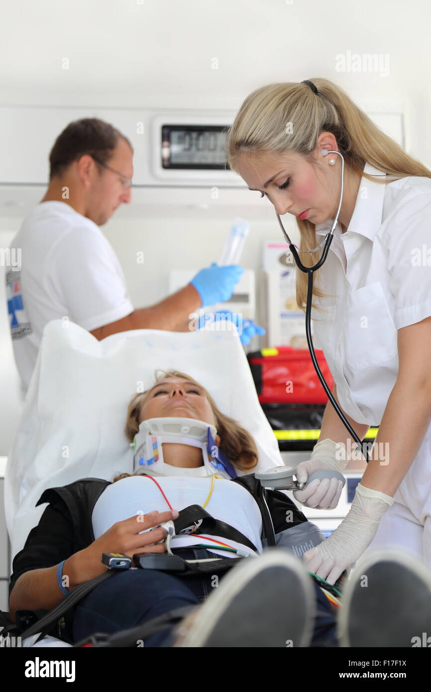 Two emergency room doctors helping a woman with Stifneck Stock Photo