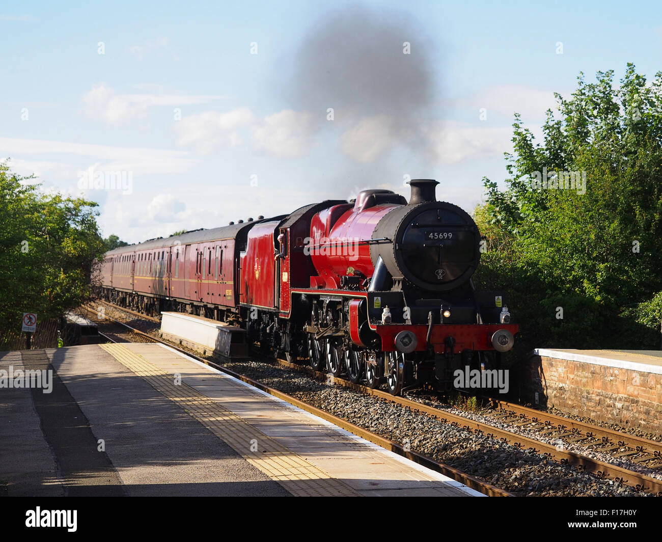 Steam train 45699 'Galatea' passing through Langwathby station on the Settle to Carlisle line in Cumbria, England. Stock Photo