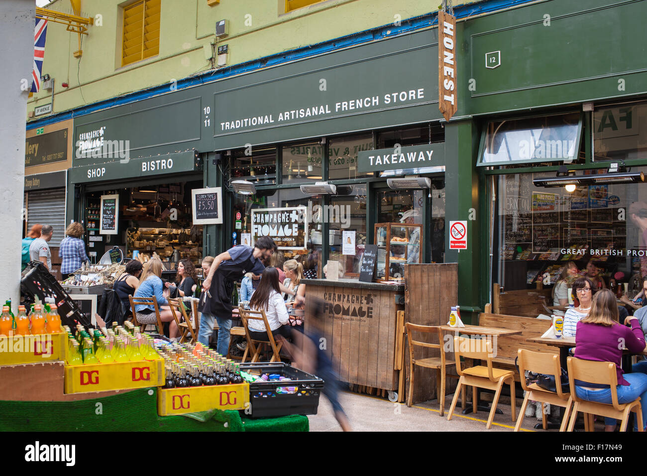 Brixton Village market, London, UK. People enjoy food and drink in Brixton Village, Brixton's iconic covered market. Stock Photo