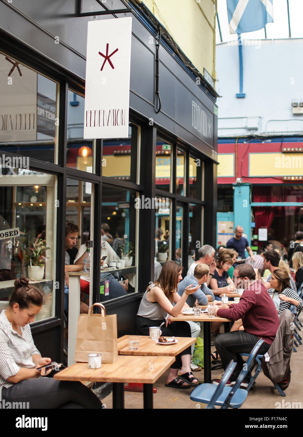 Brixton Village market, London, UK. People enjoy food and drink in Brixton Village, Brixton's iconic covered market. Stock Photo