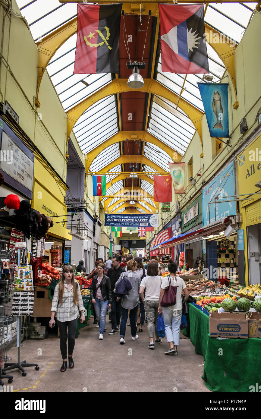 Brixton Village market, London, UK. People enjoy food and drink in Brixton Village, Brixton's iconic covered market. Stock Photo