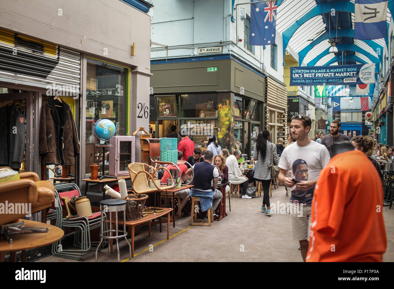 Brixton Village market, London, UK. People enjoy food and drink in Brixton Village, Brixton's iconic covered market. Stock Photo