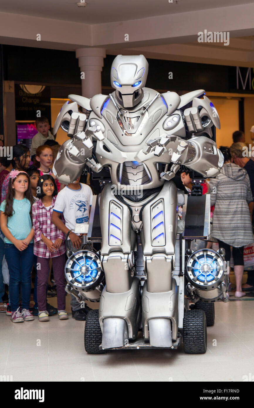 Preston, Lancashire, UK. Titan the robot, wearing an exoskeleton suit, wows  the crowds at St George's Centre. Titan is the stage name of a  partially-mechanised costume created by Cyberstein Robots Ltd. The