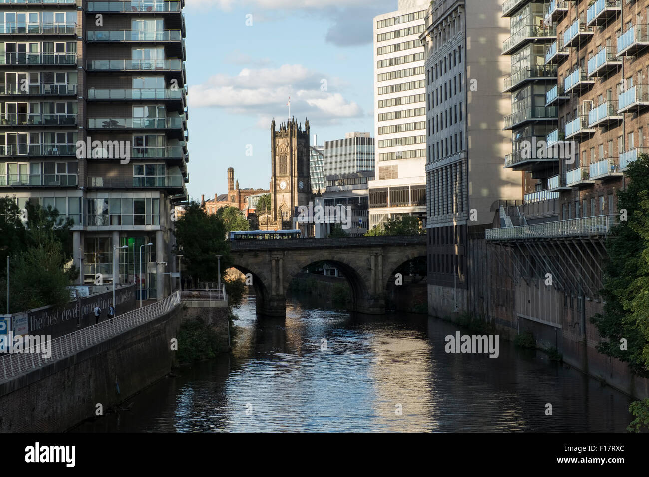 Manchester cathedral viewed from Calatrava Bridge over the River Irwell, Manchester, England Stock Photo