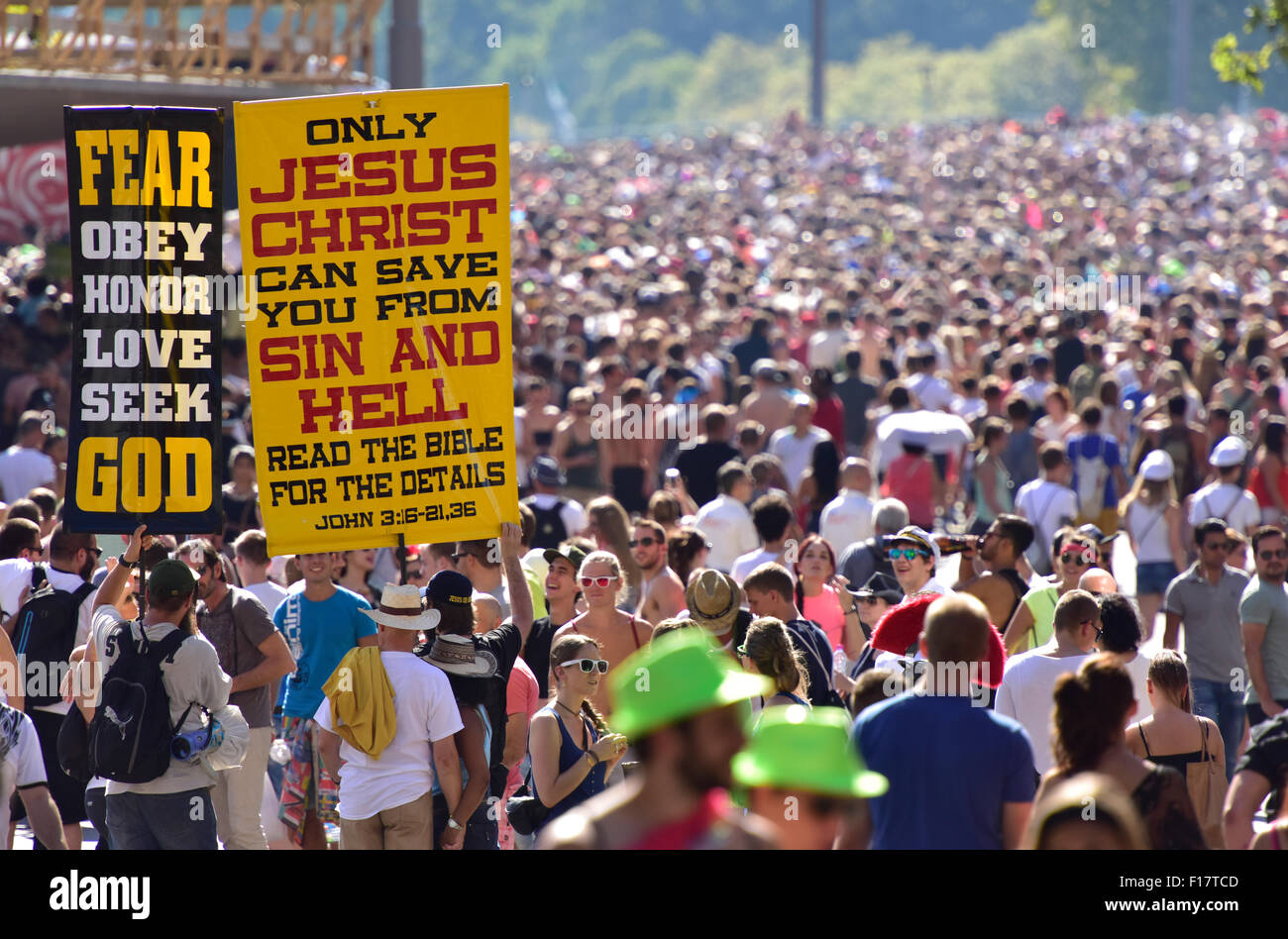 Zurich, Switzerland. 29th Aug, 2015. A small group of Christian missionaries hold up their posters, while a million people go wild in the streets at Zurich Streetparade, one of the largest techno music events. Credit:  Erik Tham/Alamy Live News Stock Photo