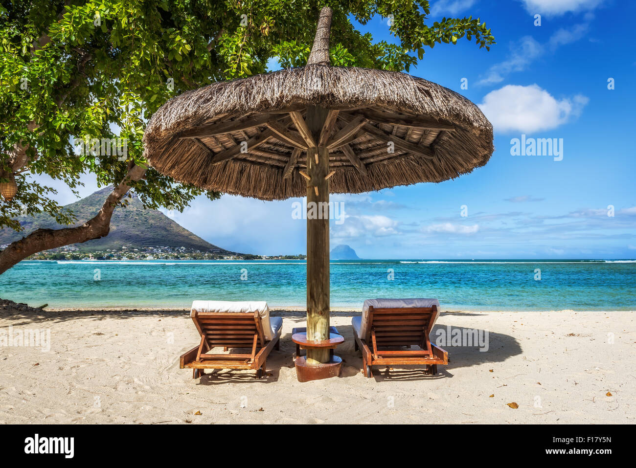 Loungers and umbrella on tropical beach in Mauritius Island, Indian Ocean Stock Photo