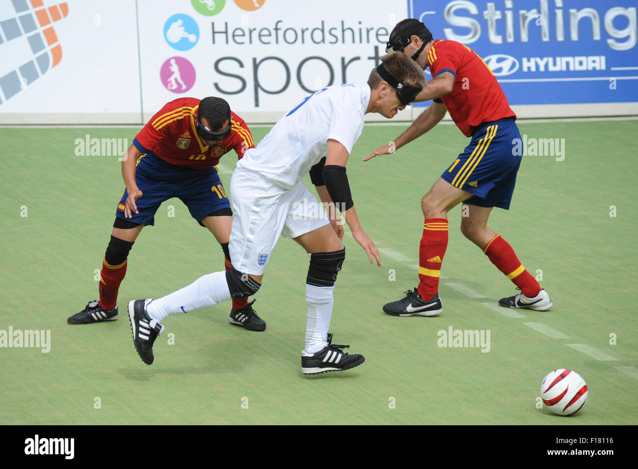 Hereford, UK. 29th Aug, 2015. IBSA Blind Football European Championships 2015 - 3rd/4th place play-off - England v Spain. Point 4, Royal National College for the Blind, Hereford. England's Robin Williams bursts past Youssef El Hadaoui & Marcelo Rosado. Credit:  James Maggs/Alamy Live News Stock Photo