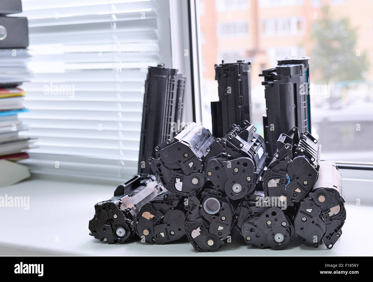 Empty cartridges from the printer stacked on the windowsill of the