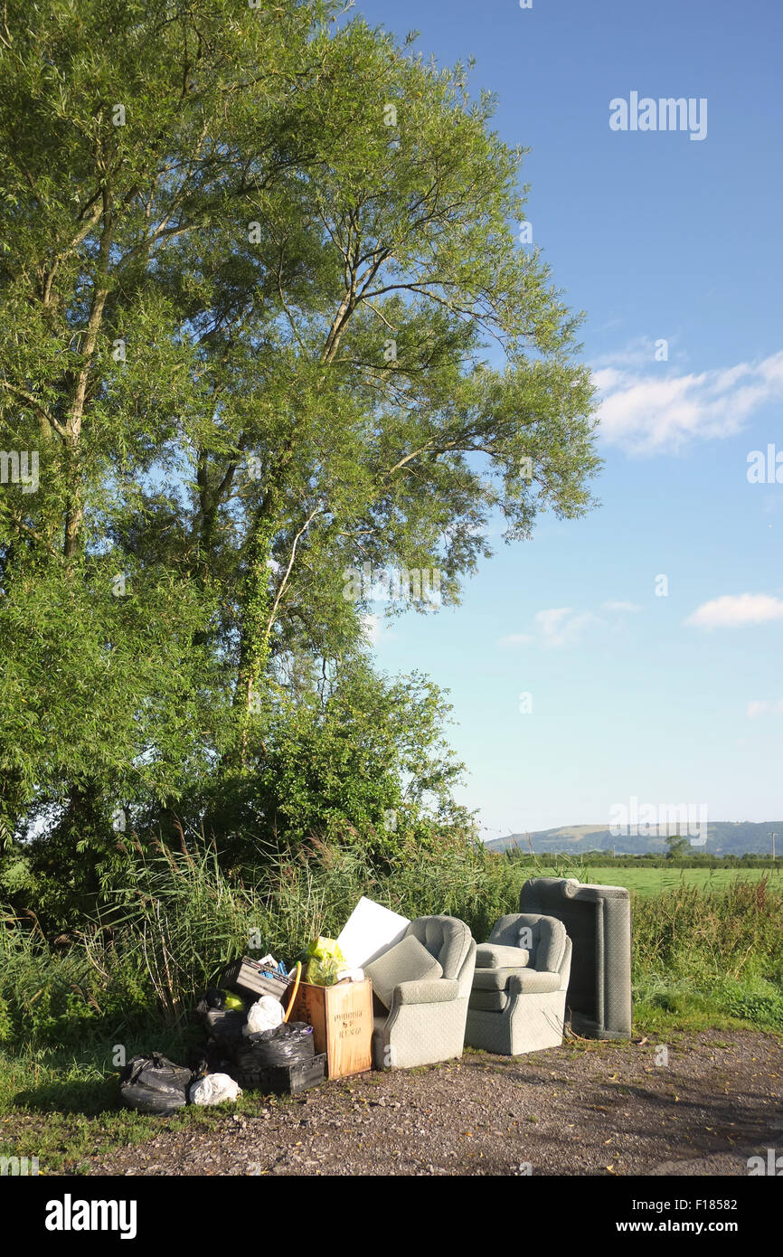 Furniture and rubbish dumped beside a rural road in Somerset near Nyland, whihc is close to Cheddar. August 2015 Stock Photo