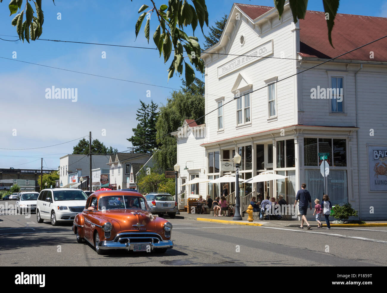Classsic Oldsmobile cruising Bay Street in Old Town Florence on the central Oregon Coast. Stock Photo