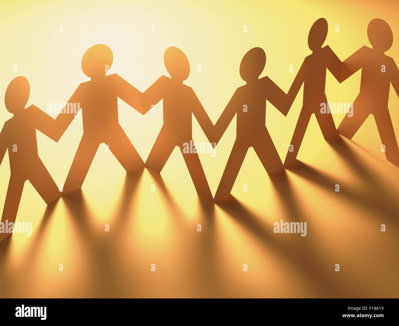 Paper cut in the shape of people together in a concept of a team. Clipping path included. Stock Photo