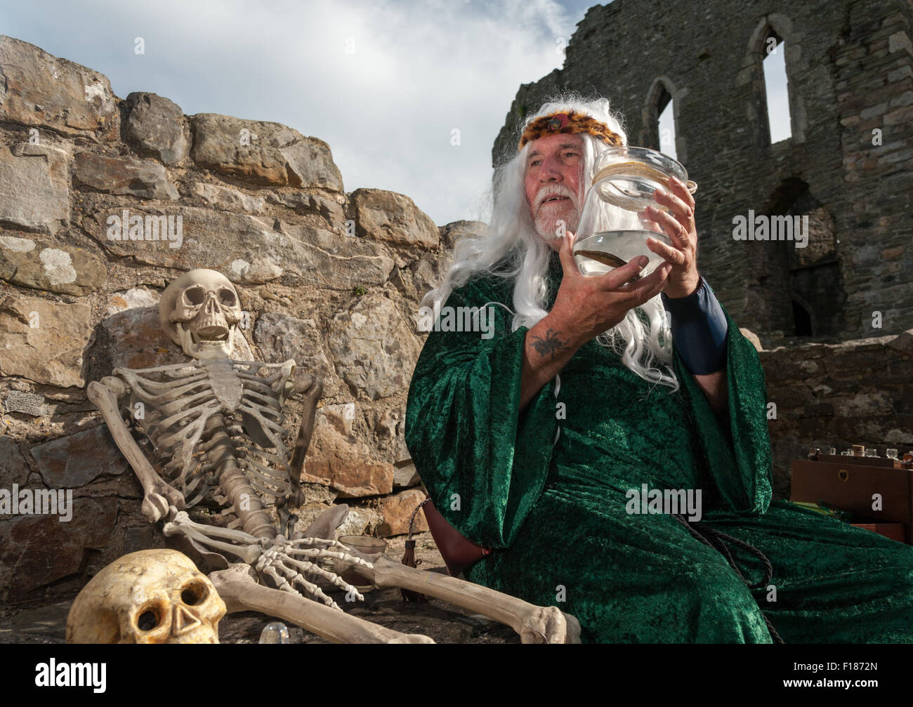 South Wales, UK, Saturday 29 August 2015. The 3rd annual Medieval Fair at Kidwelly Castle, near Llanelli, Carmarthenshire, Wales, UK. Pictured is Bob Edwards, 'Apothecary', holding one of the tools of his trade, a leach in a jar at Kidwelly Castle during bank holiday weekend. Credit:  Algis Motuza/Alamy Live News Stock Photo