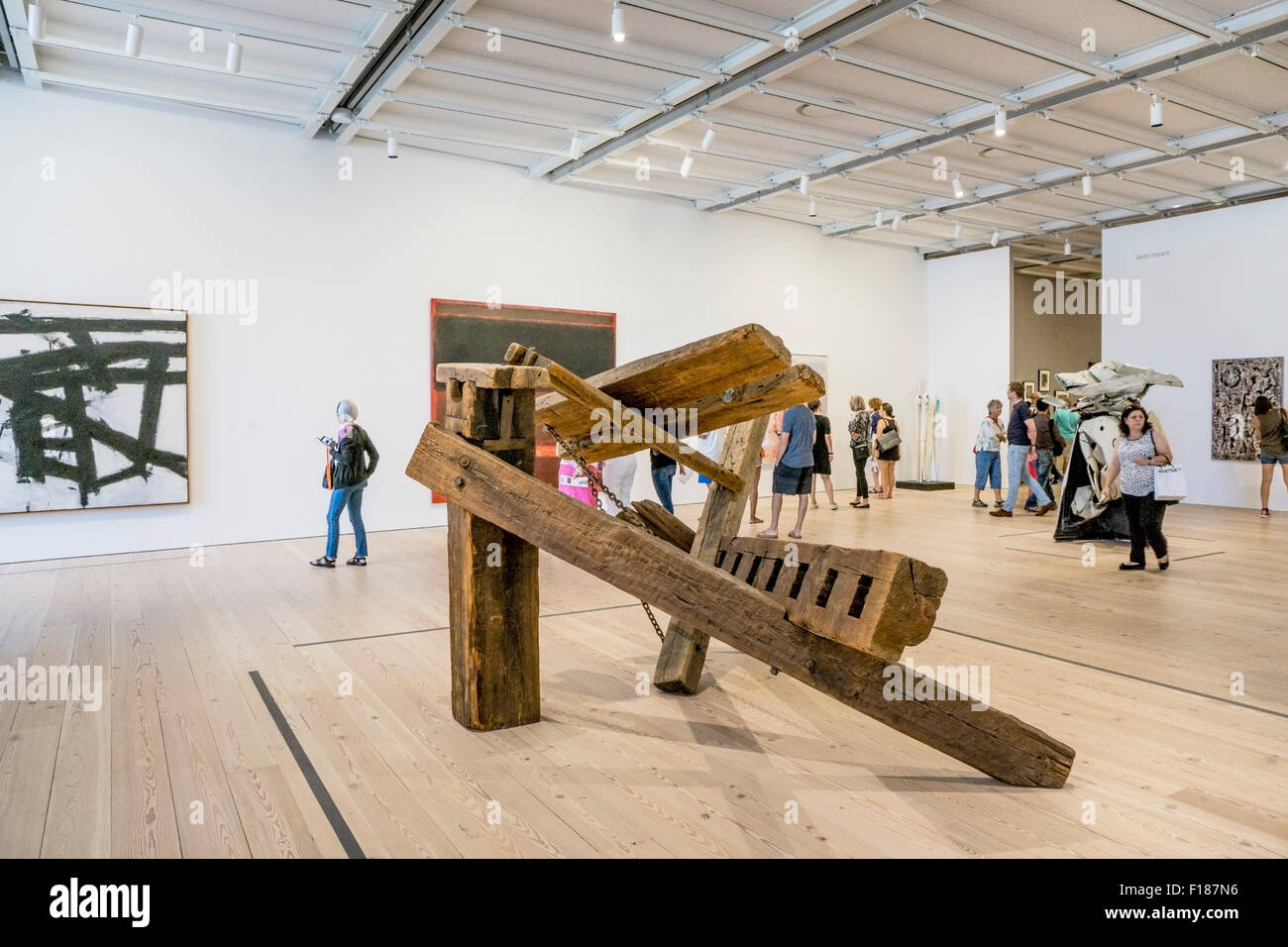 monumental wooden sculpture by Mark di Suvero at center of one of spacious lofty West galleries in new Whitney Museum Chelsea Stock Photo