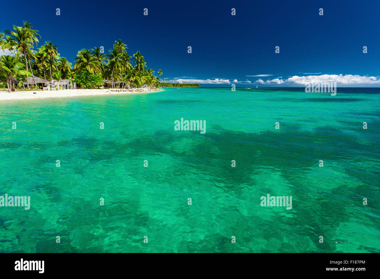 Tropical island in Fiji with sandy beach and water with coral Stock Photo