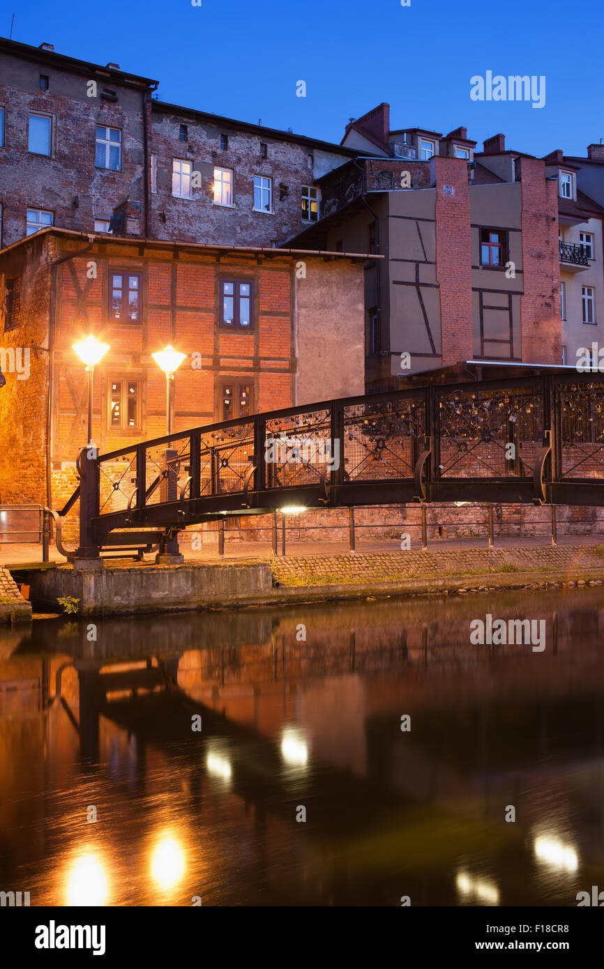 Bydgoszcz in Poland at night, picturesque old houses and footbridge