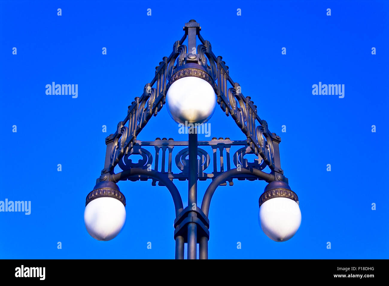 Old street lamppost on blue sky Stock Photo
