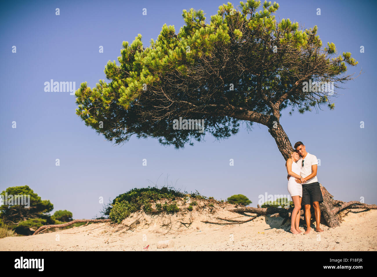 Young couple relaxing on the beach Stock Photo