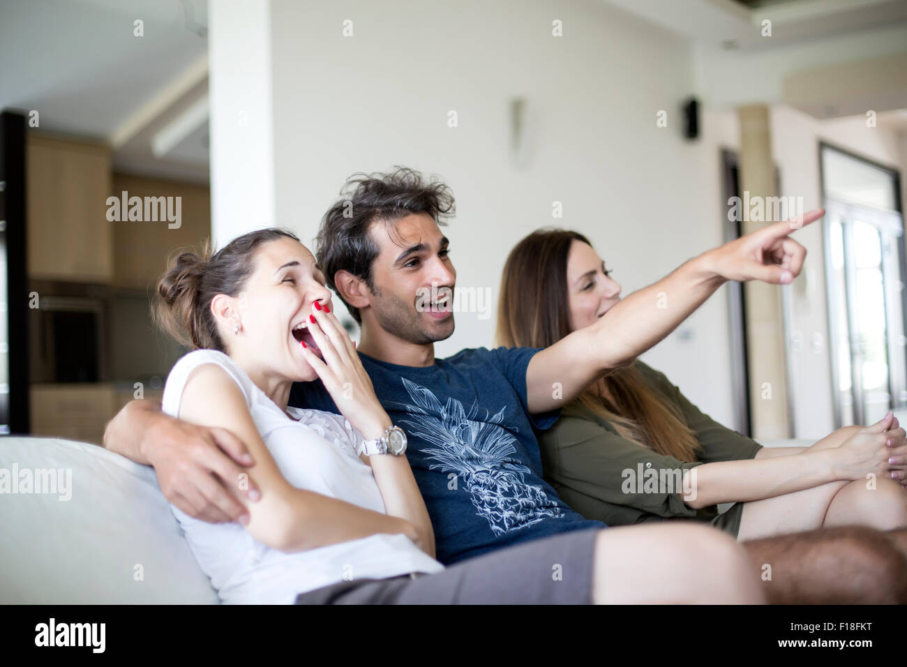 Young people watching tv Stock Photo - Alamy