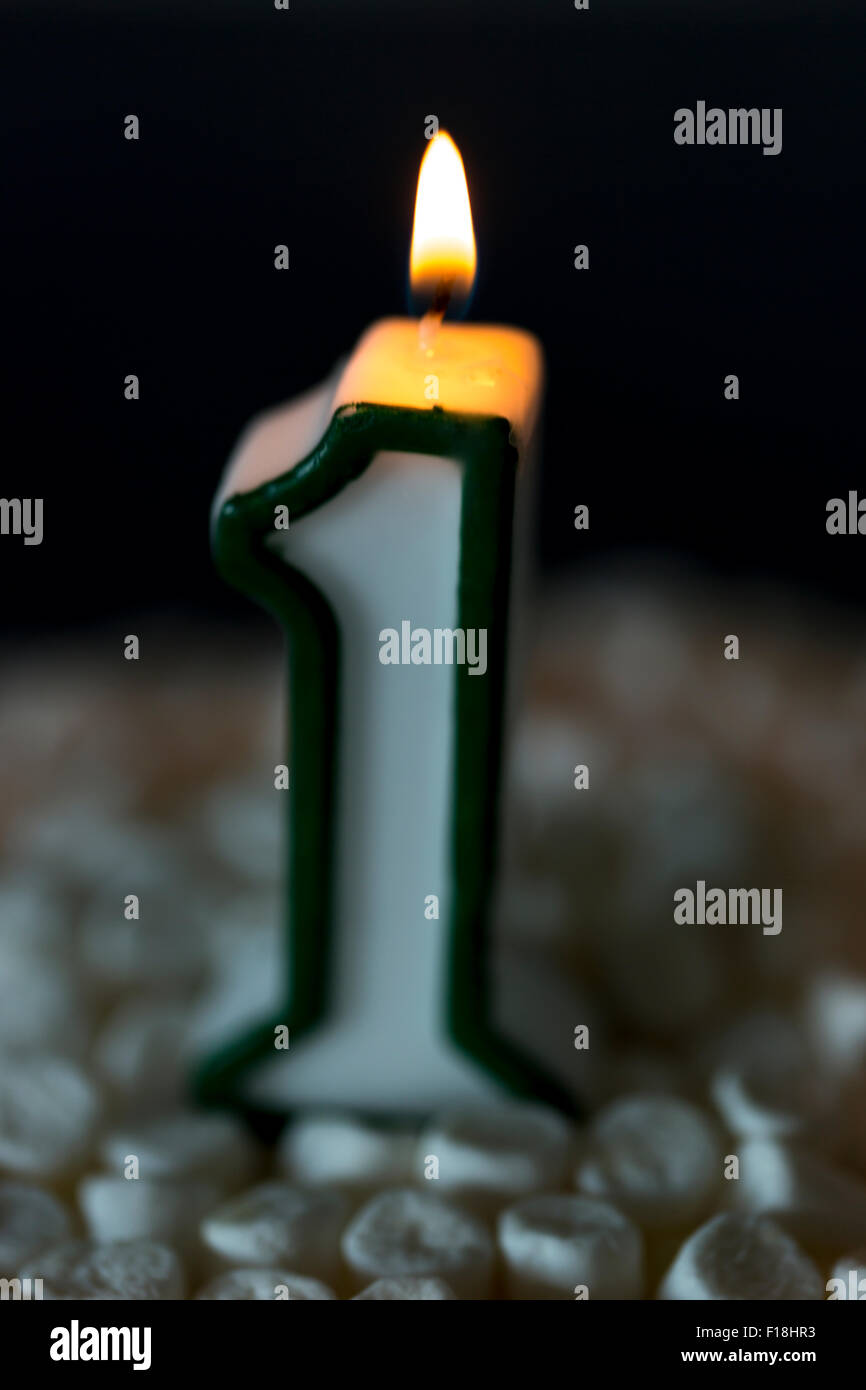 First Birthday Candle Burning. The number one. Stock Photo