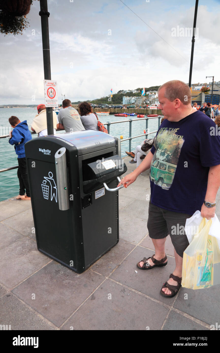Tech Litter A tourist uses a high tech litter bin on the seafront in a Cornish town ...