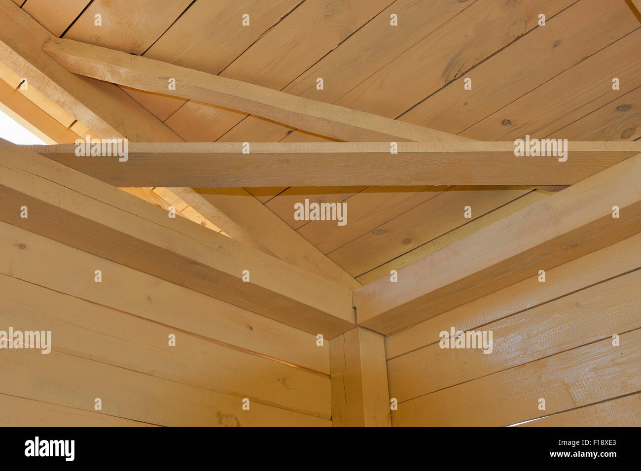 interior view of the construction of a pitched roof showing the ridge, rafters and sheathing Stock Photo