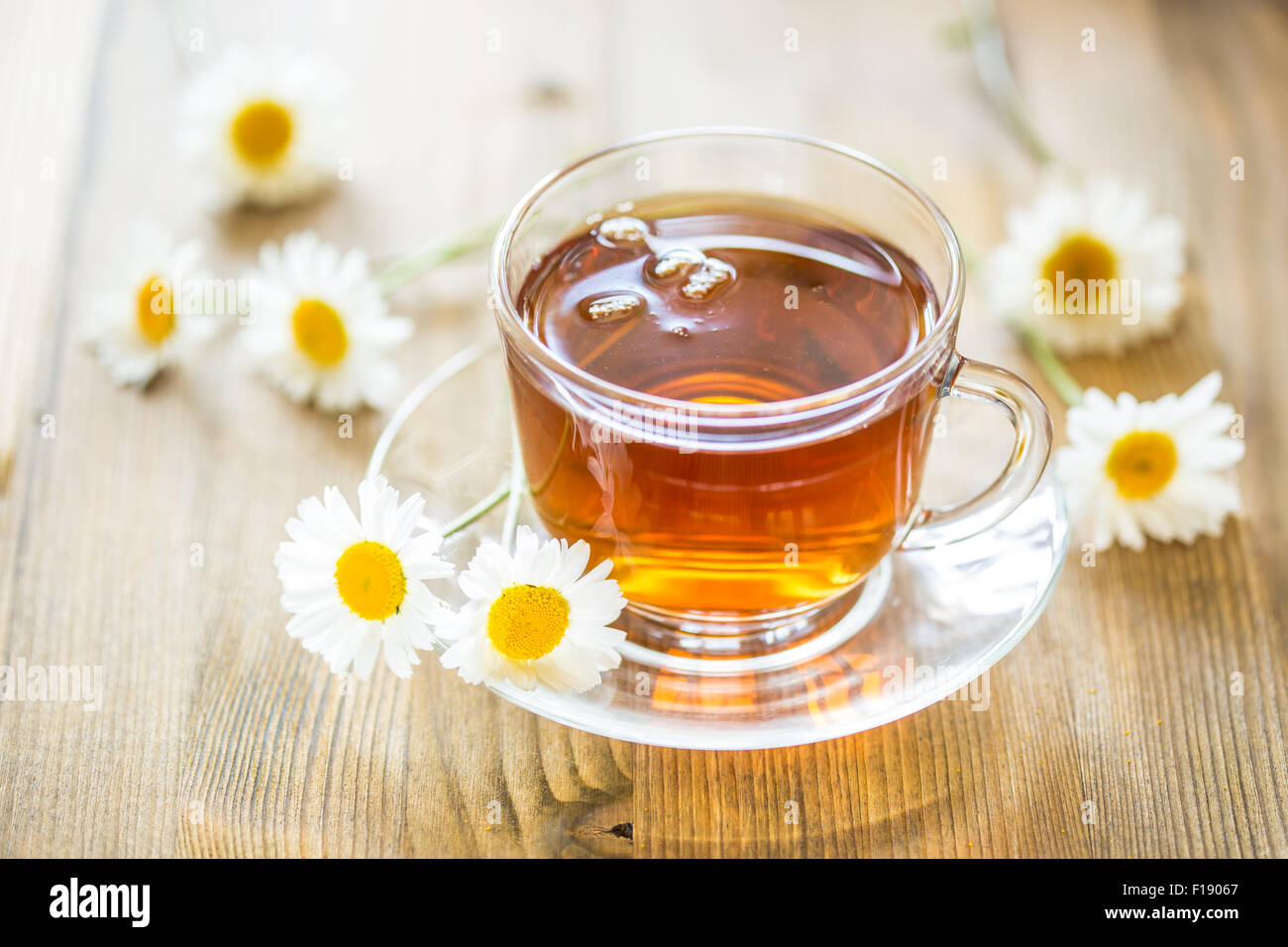 Cup of tea with chamomile flowers on rustic wooden background Stock ...