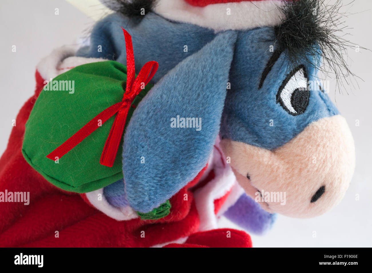 Xmas Santa Eeyore carrying sack of presents soft cuddly toy from Winnie the Pooh set on white background Stock Photo