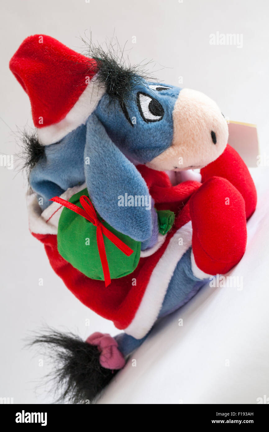 Xmas Santa Eeyore carrying sack of presents soft cuddly toy from Winnie the Pooh isolated on white background Stock Photo