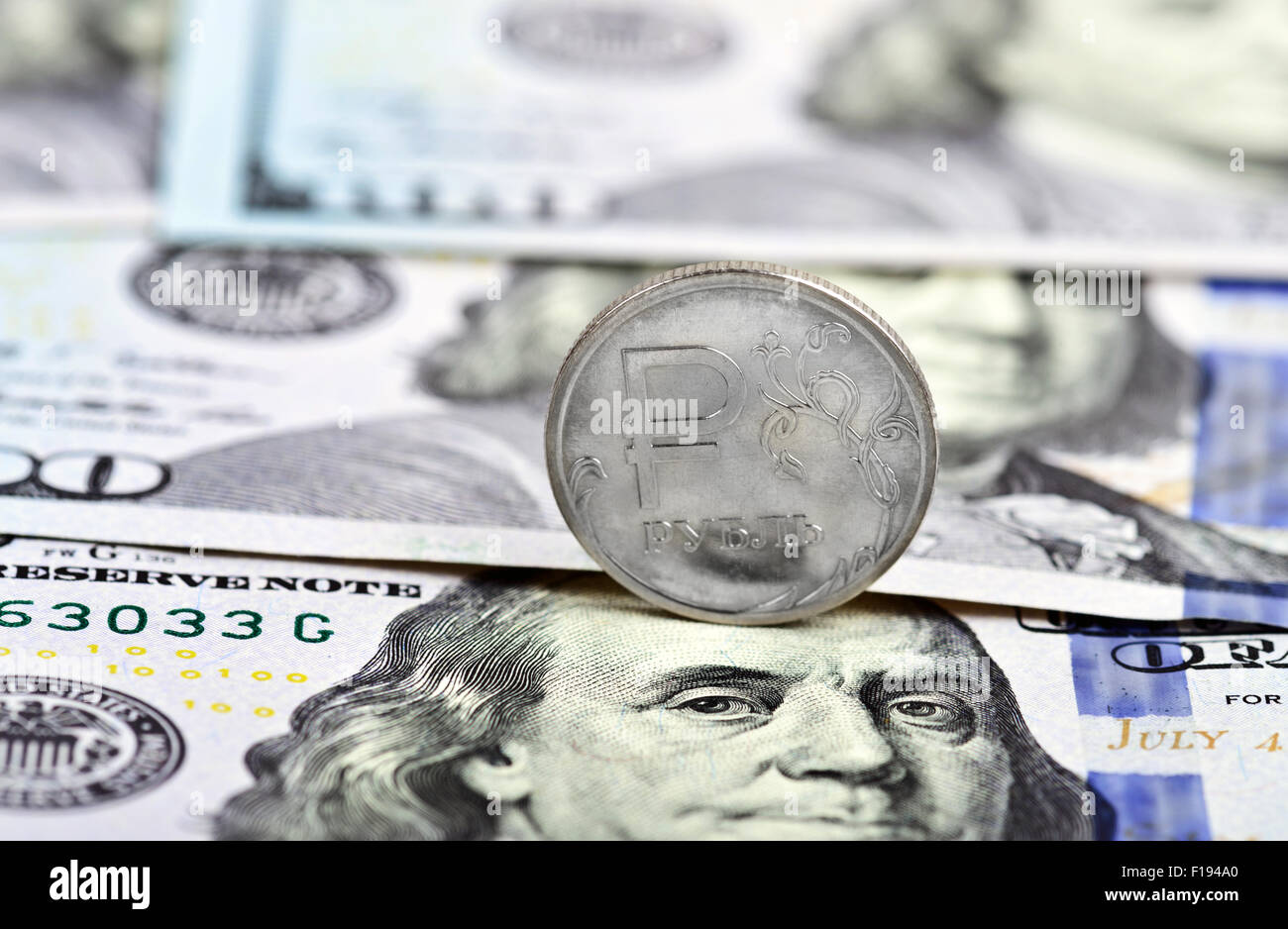 coin one ruble against the background US dollars Stock Photo