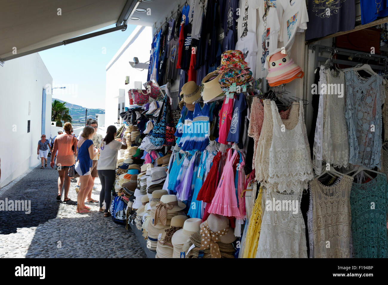 Hats and clothes on sale in an outdoor market, Santorini, Greece Stock