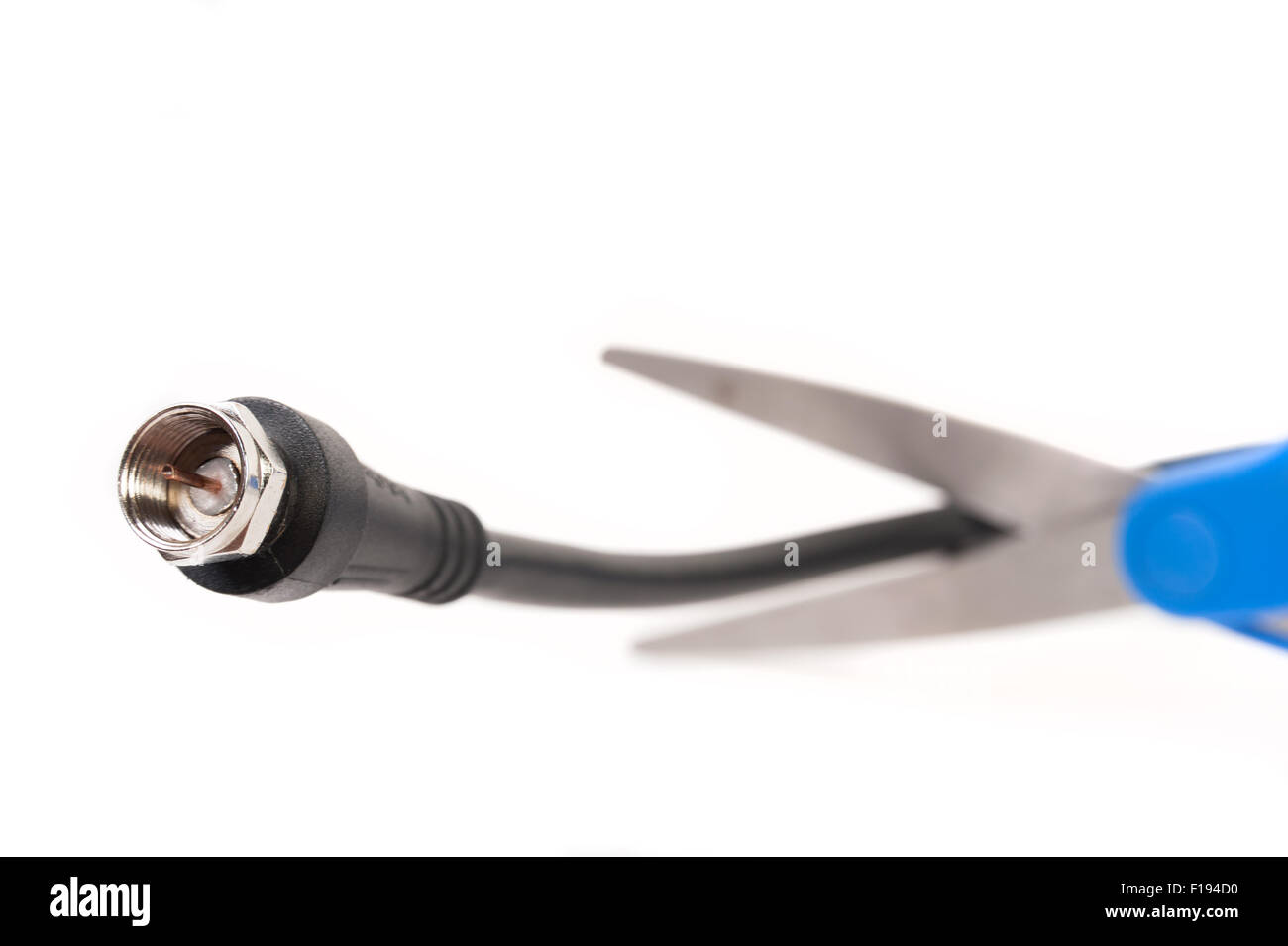 Scissors cutting through a coaxial RG6 cable cut the cable tv concept