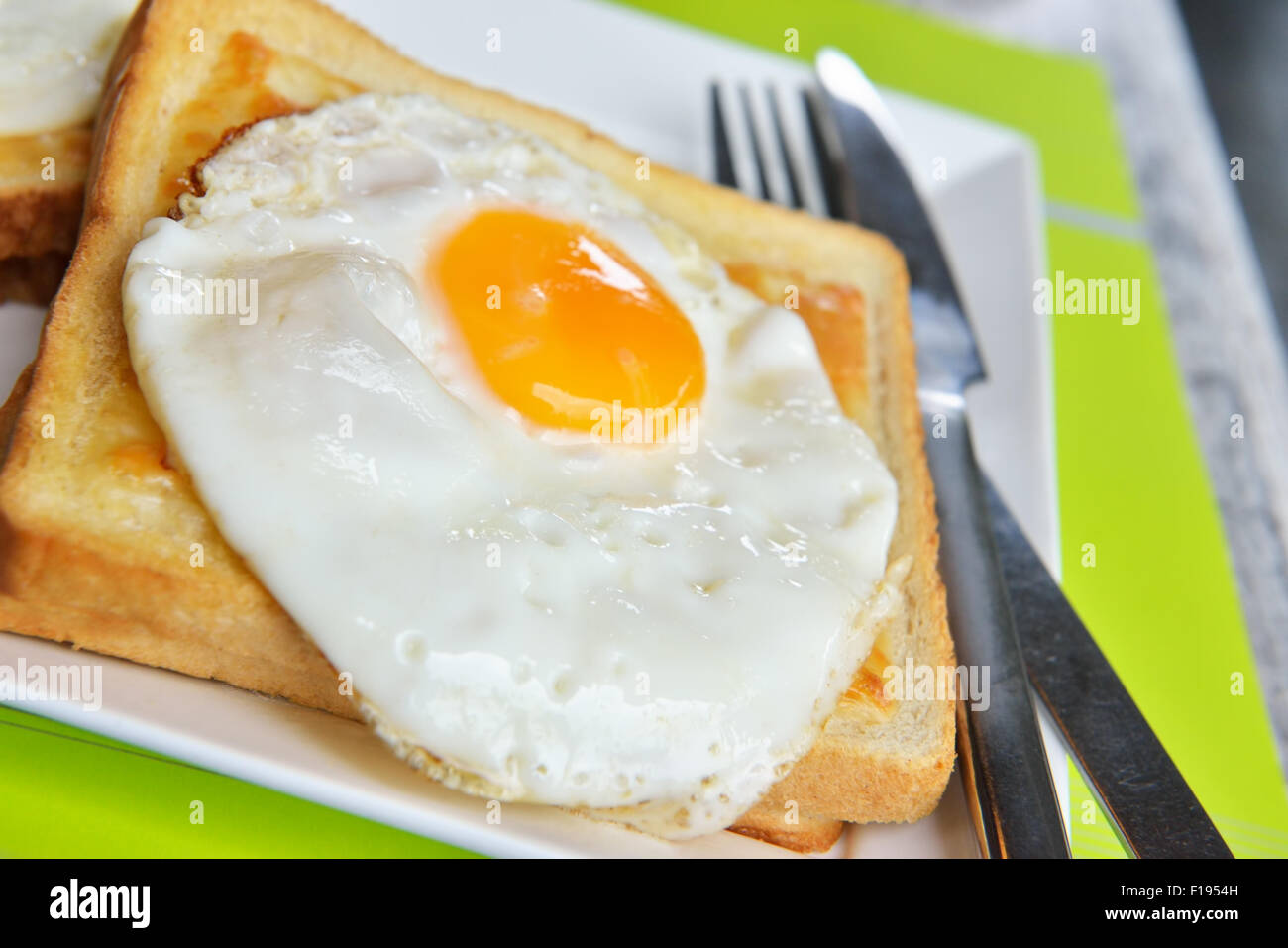 Dish croque-madame with beautiful fried eggs, bread and ham, shallow DOF in natural light closeup image Stock Photo