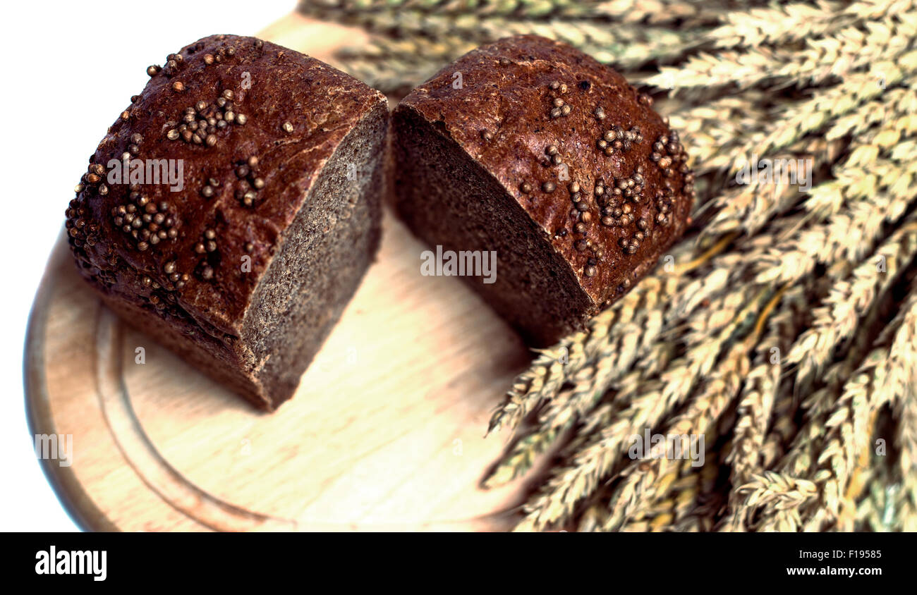 fresh bread with wheat ears against white background Stock Photo - Alamy