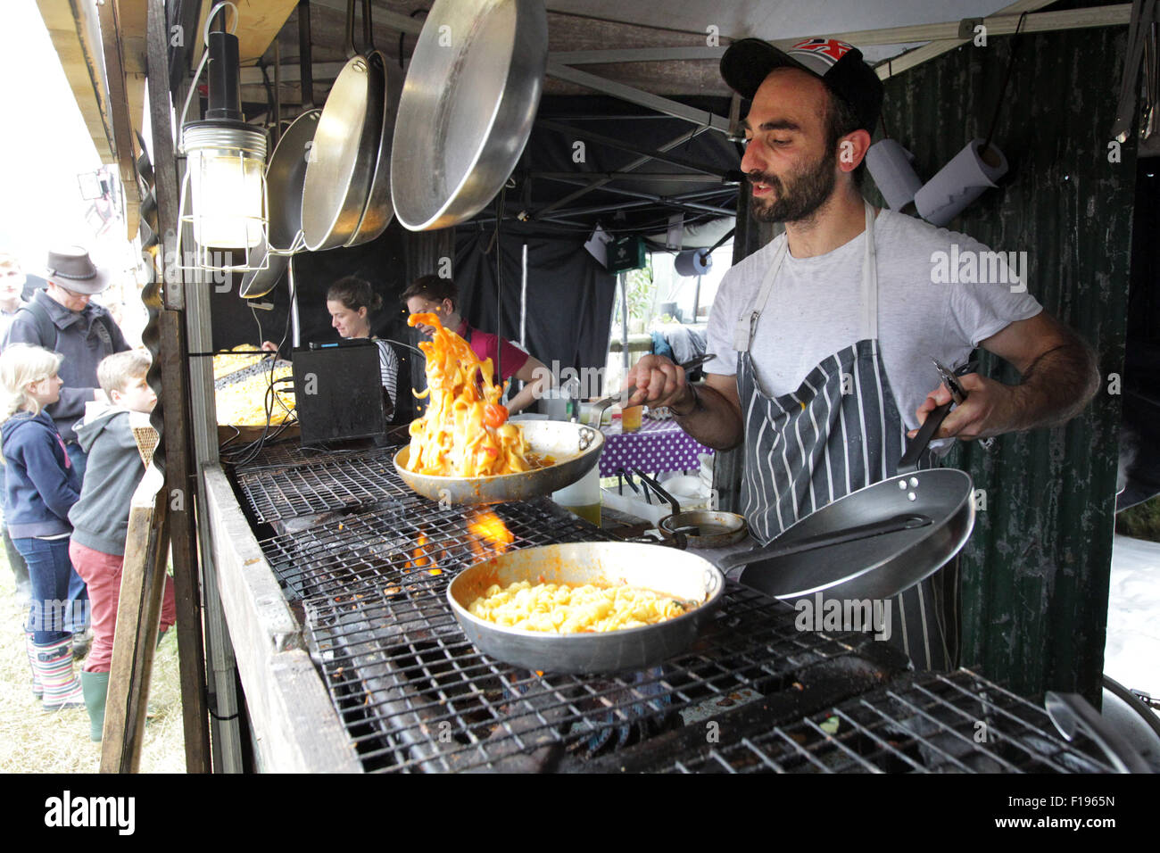 Kingham, Oxfordshire, UK, Sunday 30th August 2015. A chef prepares