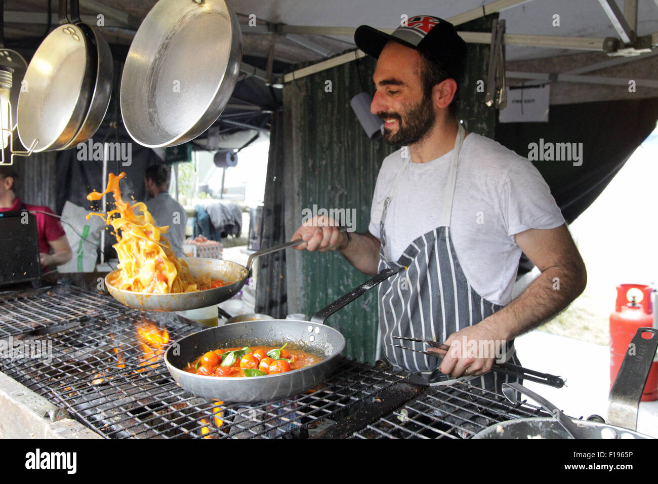 Kingham, Oxfordshire, UK, Sunday 30th August 2015. A chef prepares