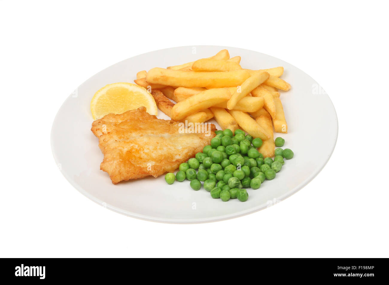 battered fish, chips and peas with a wedge of lemon on a plate isolated against white Stock Photo