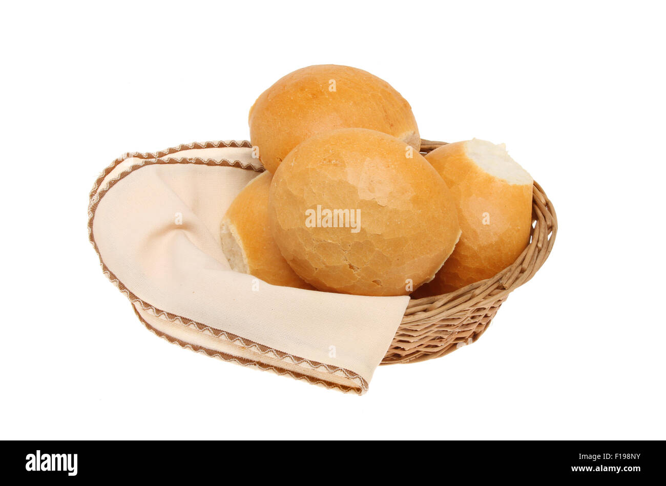 Crusty bread rolls in a basket with a serviette isolated against white Stock Photo