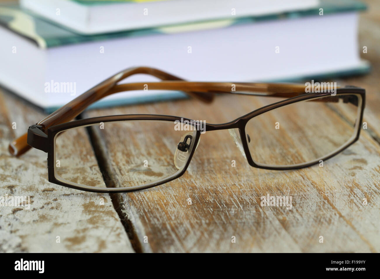 Glasses with stack of books in the background Stock Photo