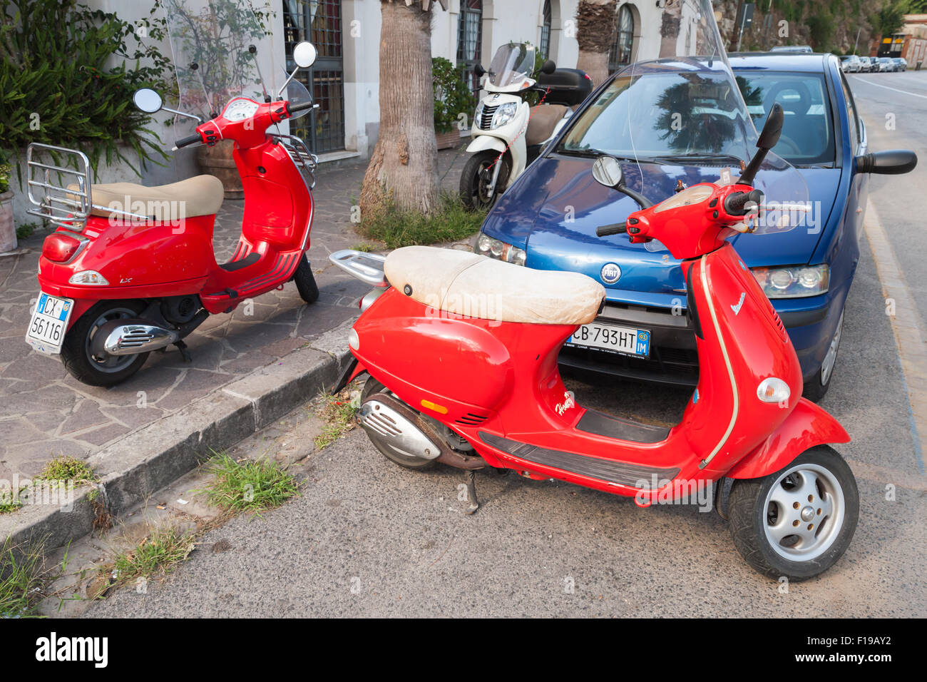 Gaeta, Italy - August 24, 2015: Classic red Vespa scooters parked on a roadside Stock Photo