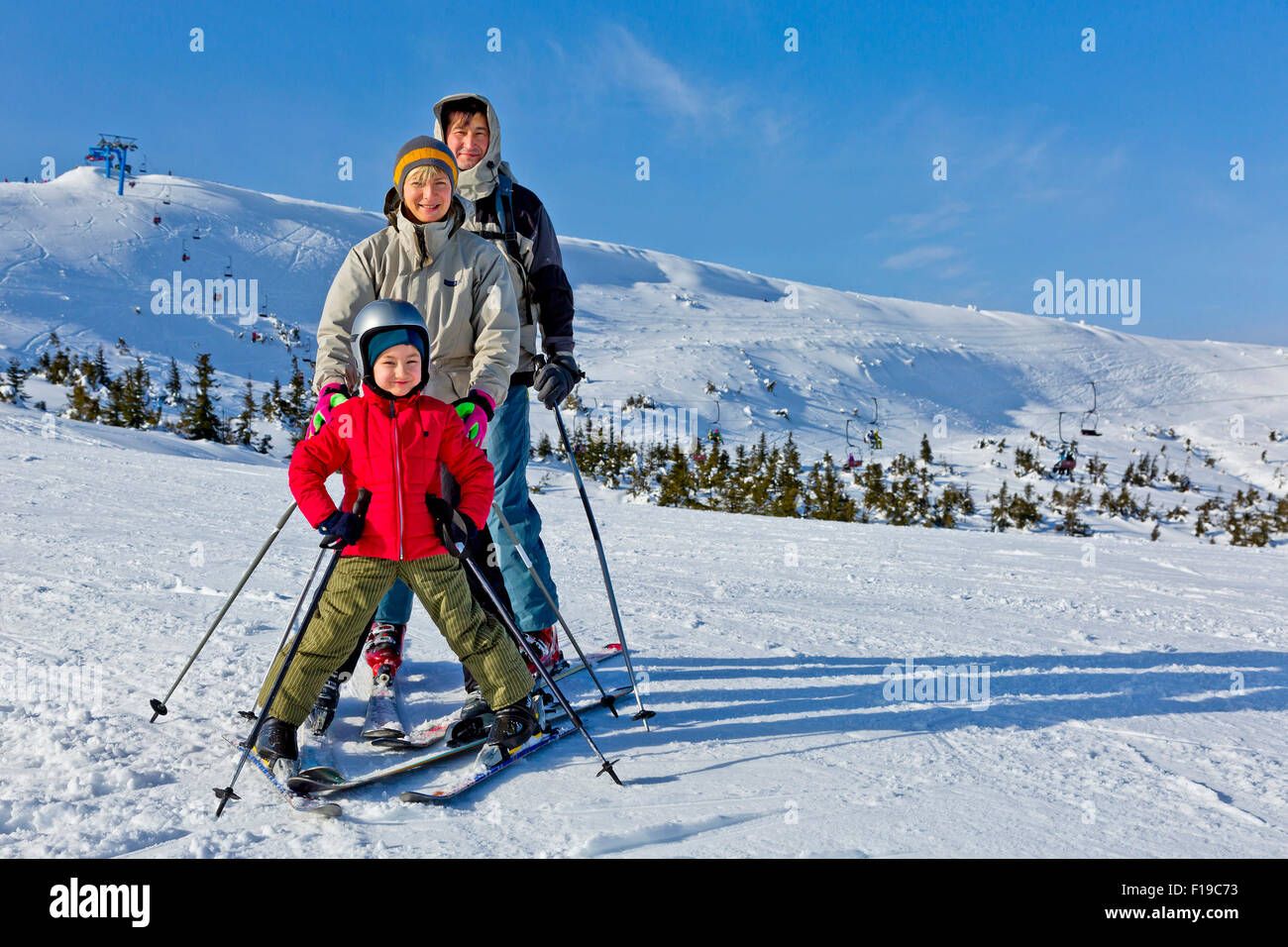 Cute Girl Skier Skiing With Family On Mountain Stock Photo, Picture and  Royalty Free Image. Image 88410842.