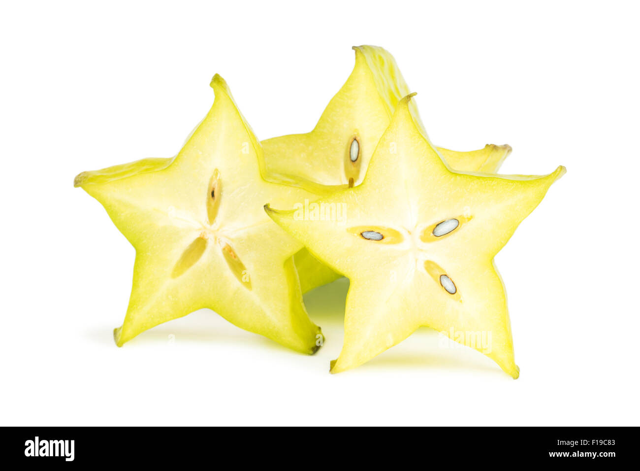 Close-up of three carambola (starfruit) slices, viewed from the front, isolated on white background. Stock Photo