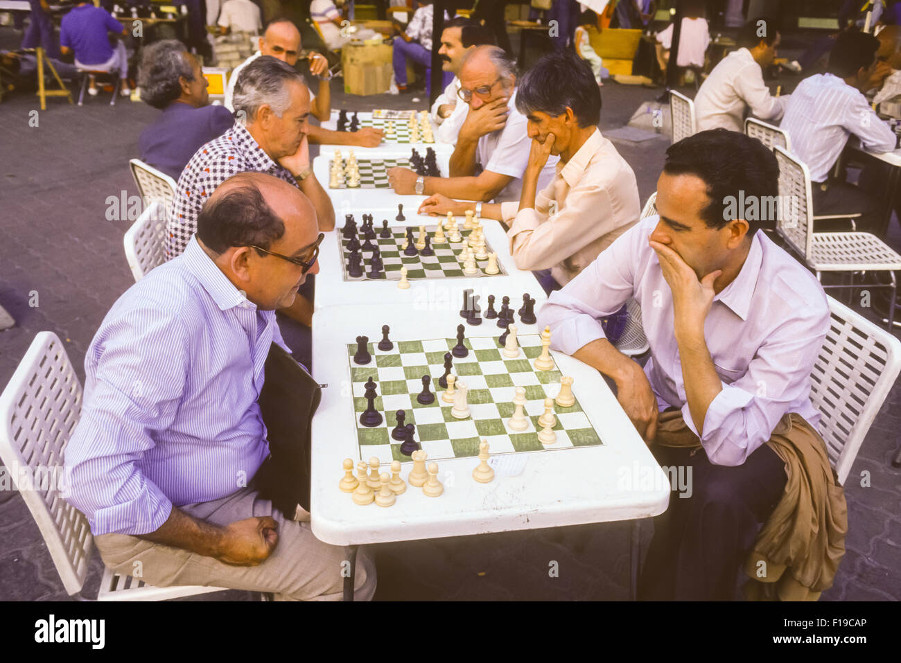 CARACAS, VENEZUELA - Men playing chess outdoors on Sabana Grande pedestrian mall. 1988 Stock Photo