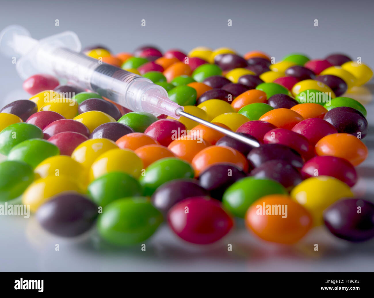Syringe with candy, diabetes Stock Photo - Alamy