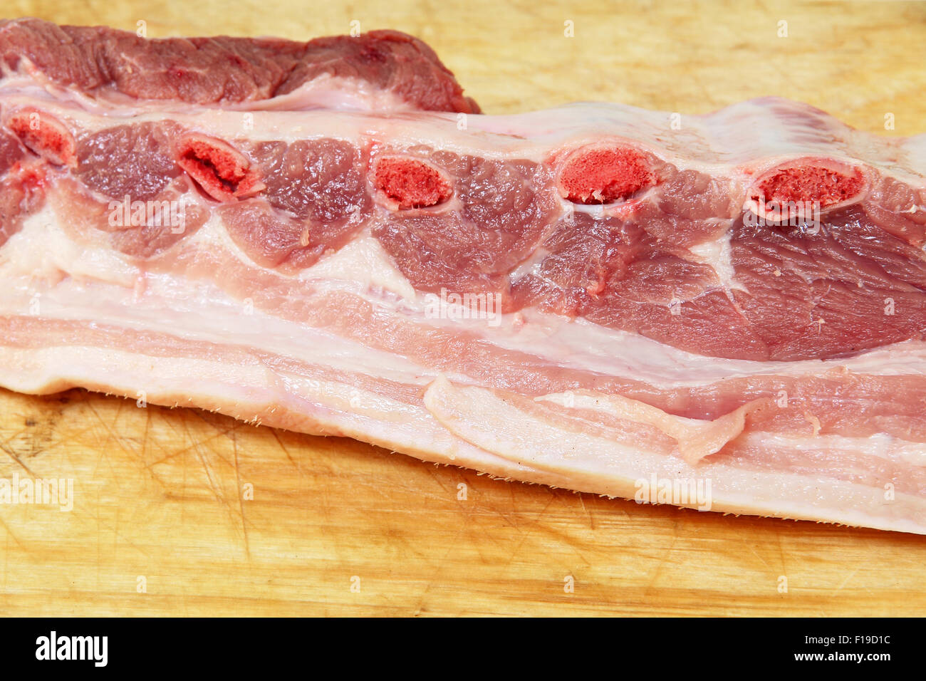 Appetizing raw pork ribs on wooden cutting board. Stock Photo
