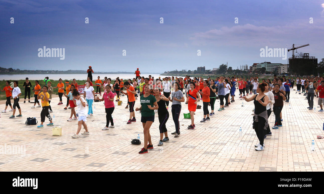 Aerobics exercise keep fit on banks of Mekong River Stock Photo