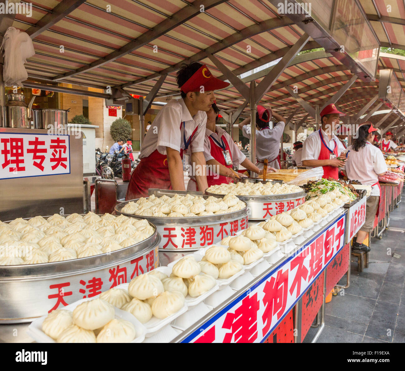 Dumpling vendors wait for customers at Wanfujing St night food market in Beijing China Stock Photo