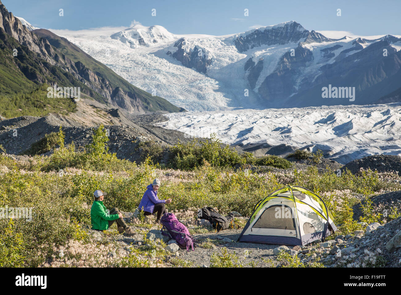 Campers head out on a hike along the Root glacier at Wrangell St. Elias National Park July 20, 2015 in Alaska. Stock Photo