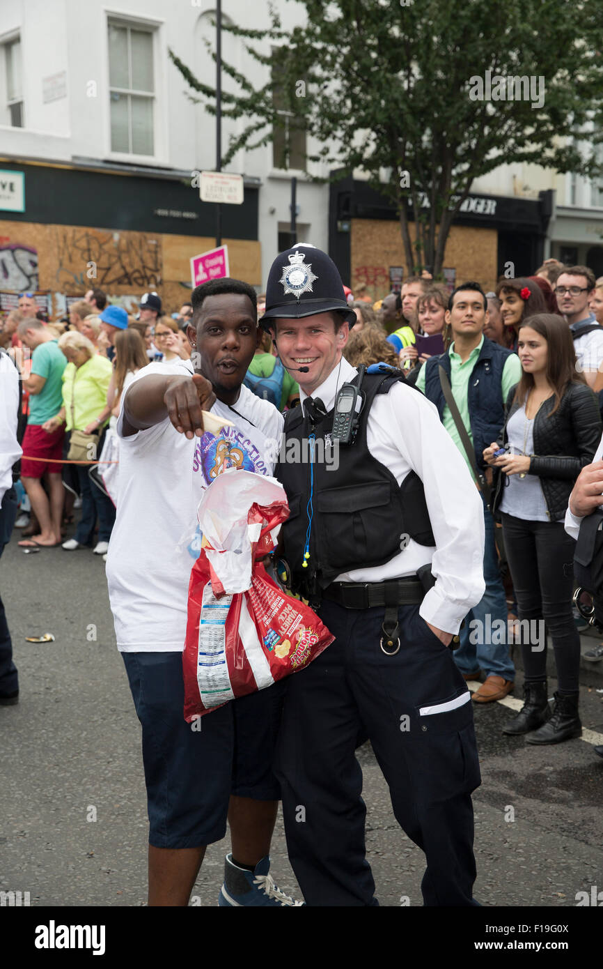 Notting Hill,UK,30th August 2015,Partygoers and police have fun at the Notting Hill carnival childrens parad Credit: Keith Larby/Alamy Live News Stock Photo