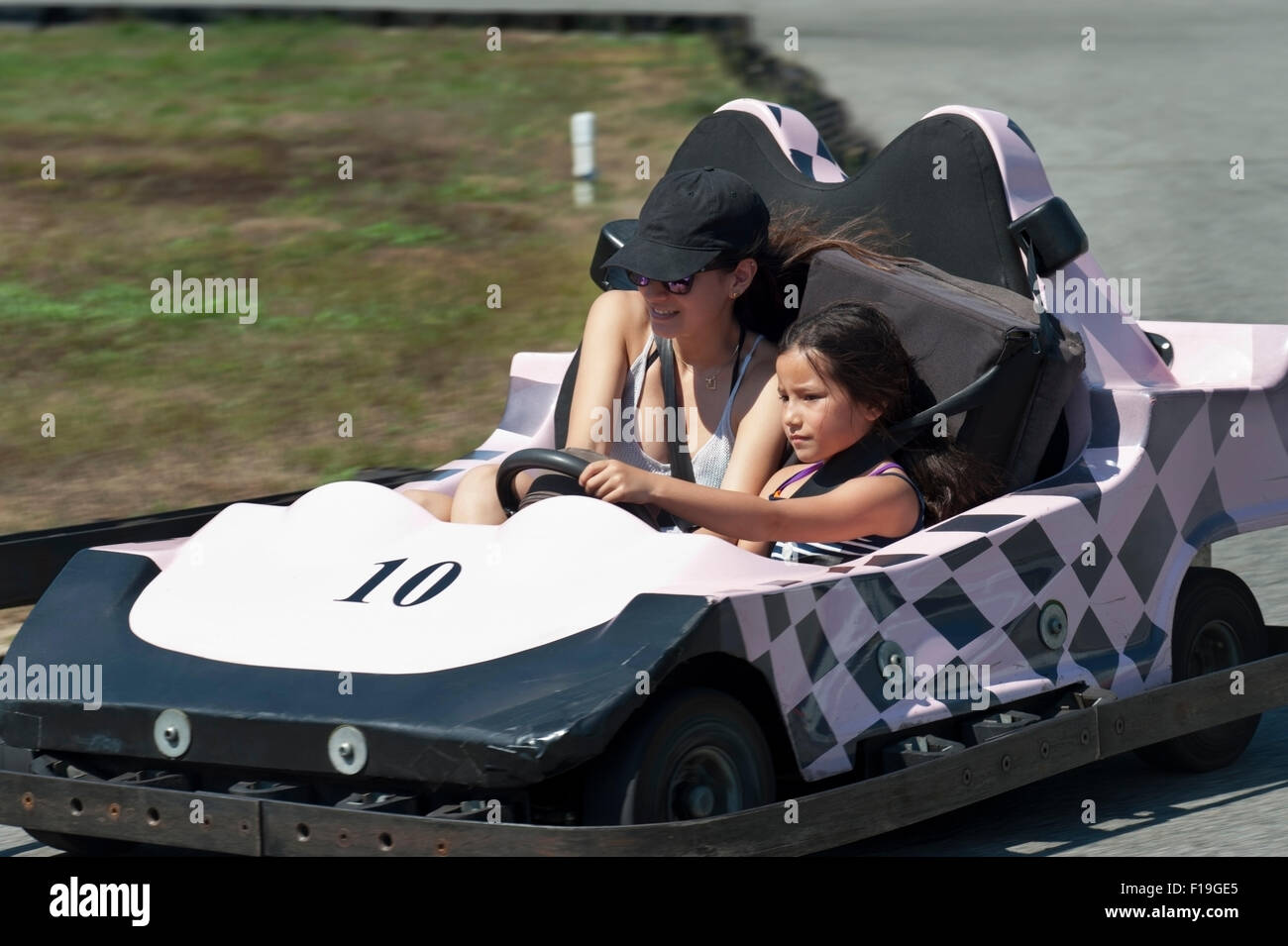 Seven yearold drives her 16 yearold sister on a GoKart Track at Cape Cod, MA during summer