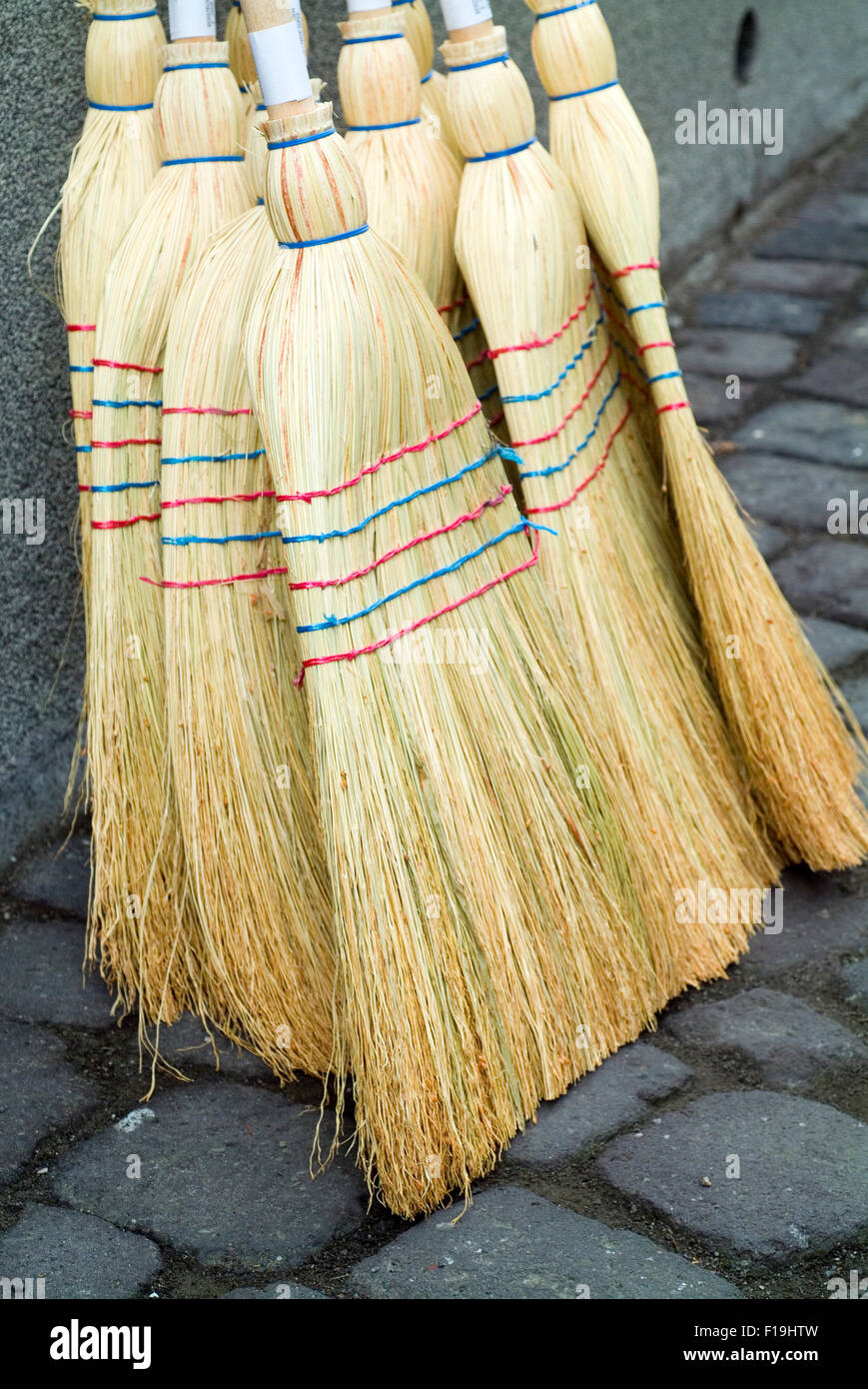 Brooms from nature materials on a market stall Stock Photo